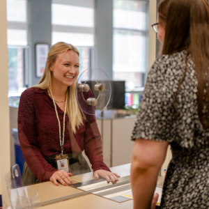 Staff at service window serving a customer